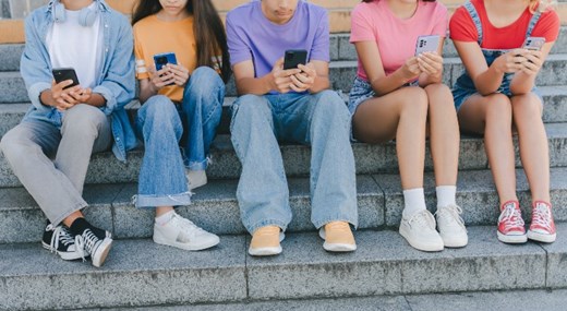 Teenagers looking at mobile phones