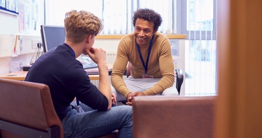 Image of a teacher talking to a student