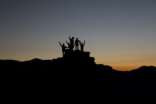 Young people on top of rock face